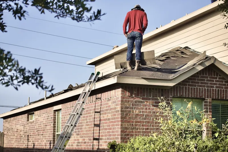 Professional roofer working on a residential roof in Pearland